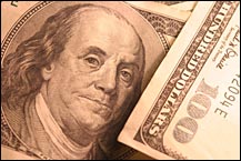 Image of 100 dollar bills in sepia tone tint
